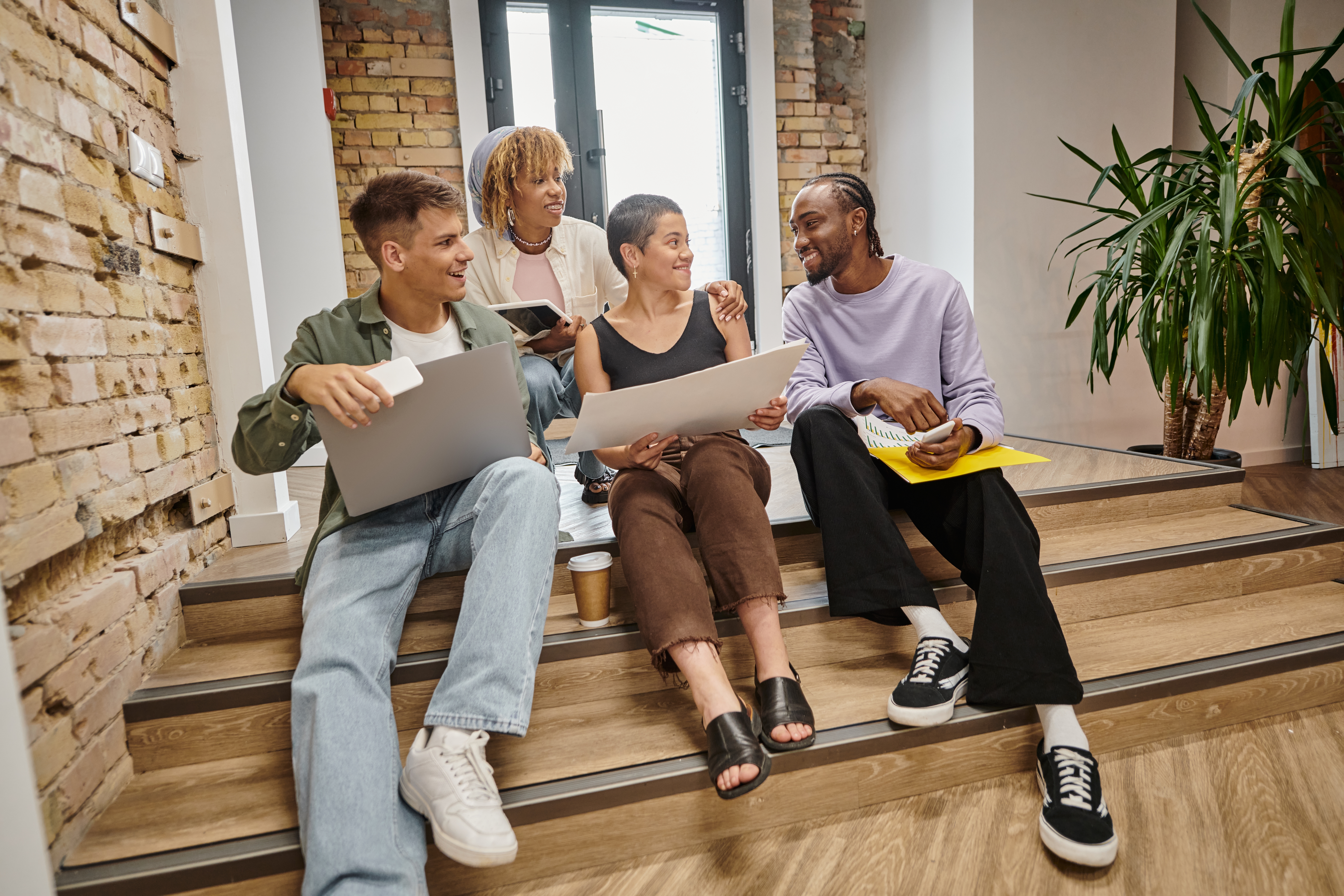 A happy sales team working on something in their office.
